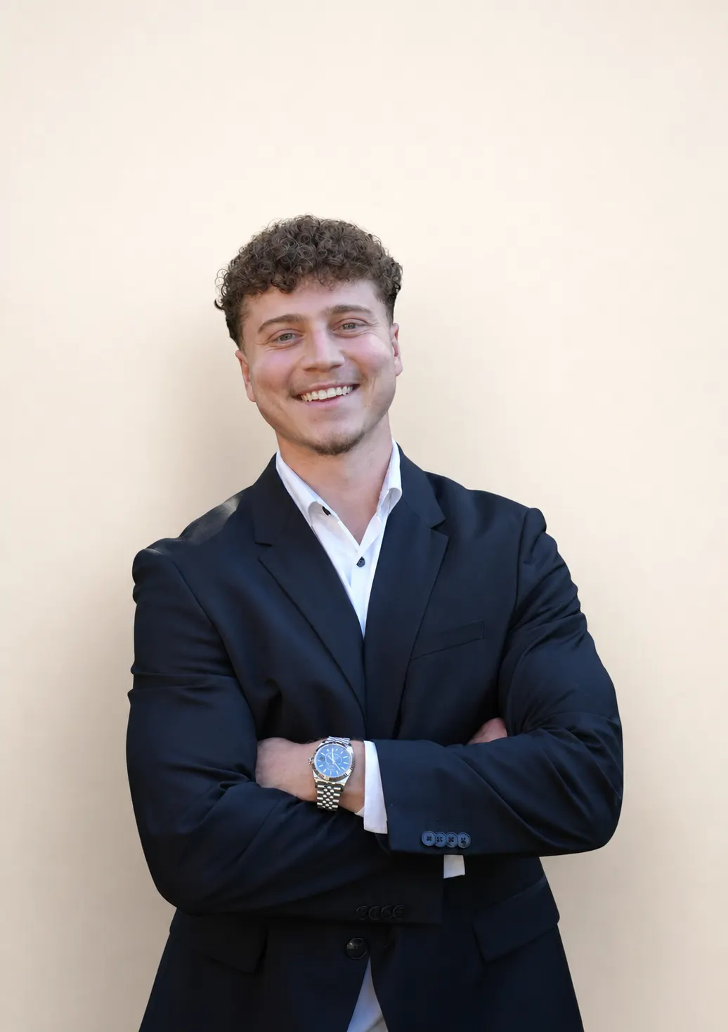 Abdul Bdaiwi, Founder and CEO of Allure RT MX, in a navy suit with arms crossed against a warm neutral backdrop