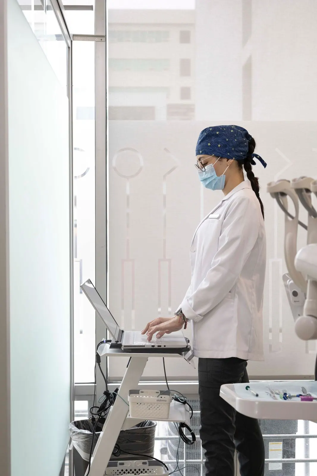 A Dental Team 1 member at the treatment-planning workstation reviewing a laptop screen