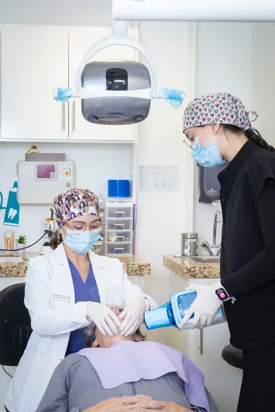 Two dental clinicians working chair-side on a patient at San Miguel Dental in Tijuana
