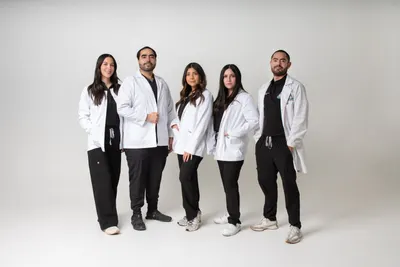 The Highland Dental clinical team in white lab coats, group portrait