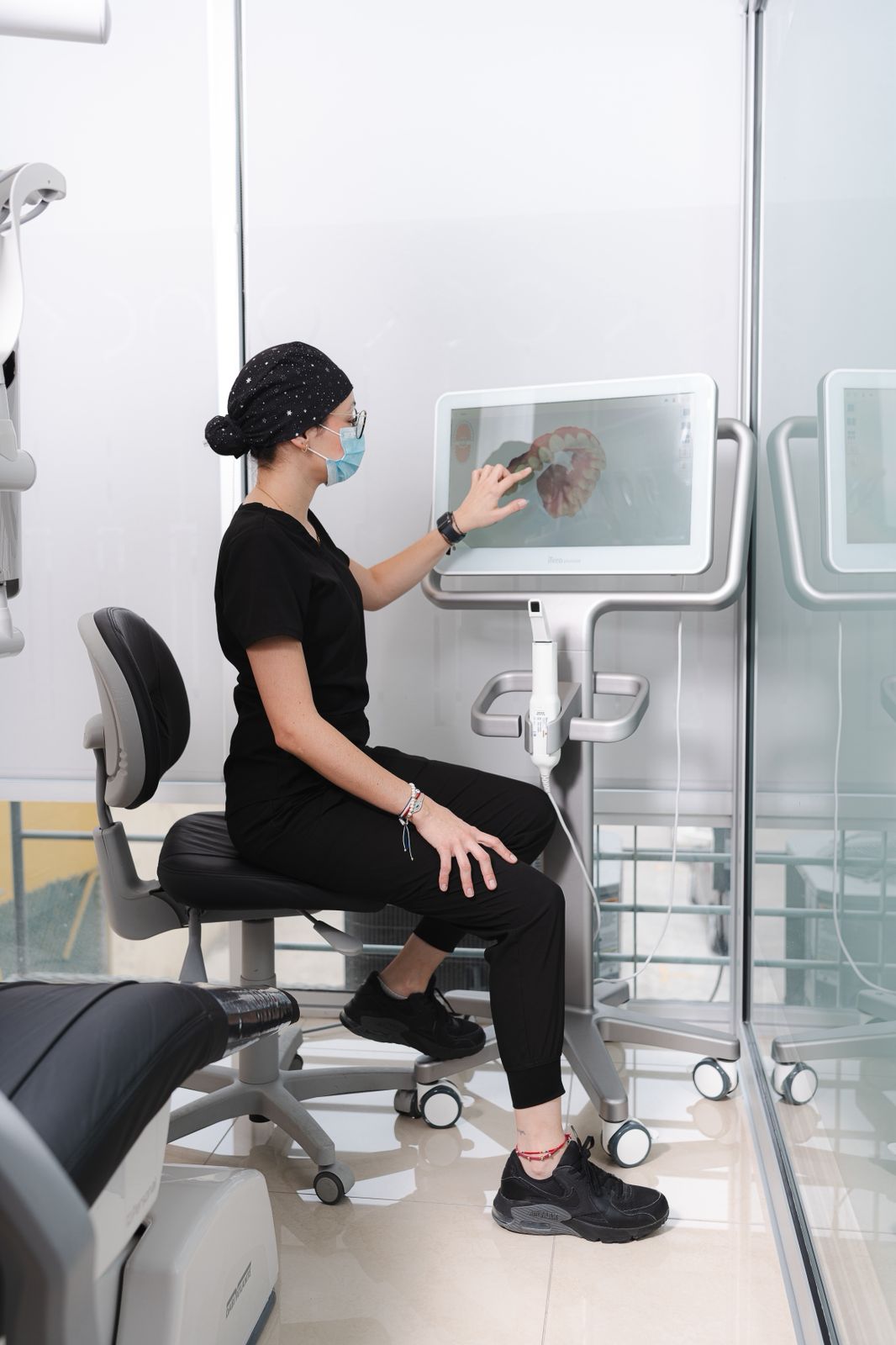 An Allure Dental team member reviewing a tooth diagram on a treatment-planning workstation