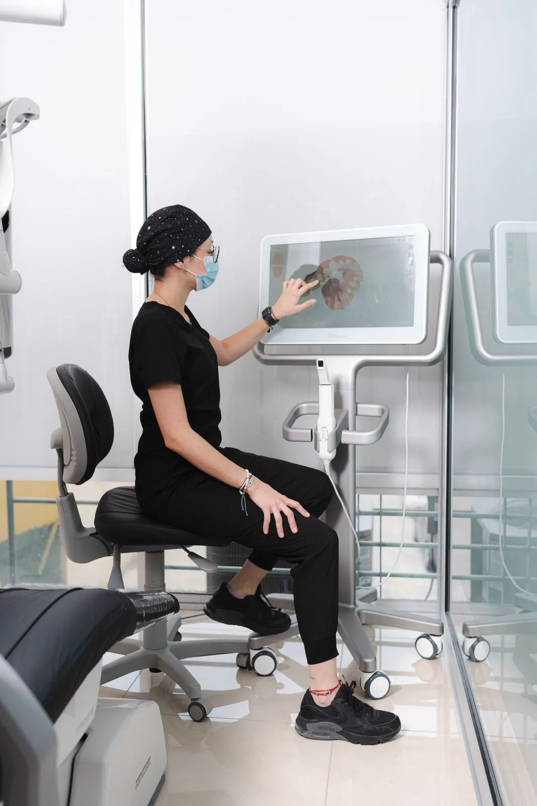 A Dental Team 1 member reviewing a tooth diagram on a treatment-planning workstation