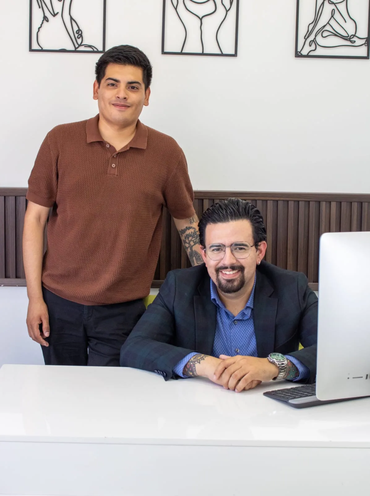 Dr. Eduardo Moreno with a member of his hair restoration team at the consultation desk