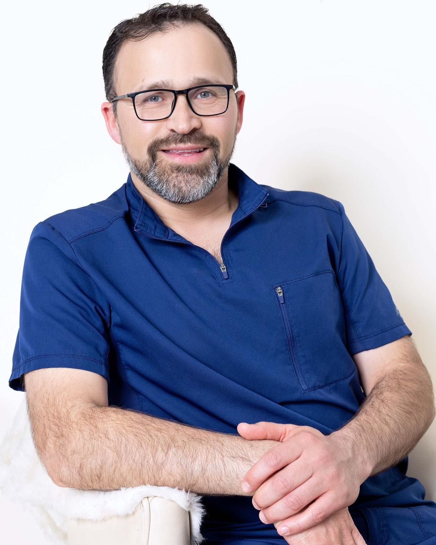 Dr. Marcos Casta&ntilde;eda studio portrait in surgical scrubs