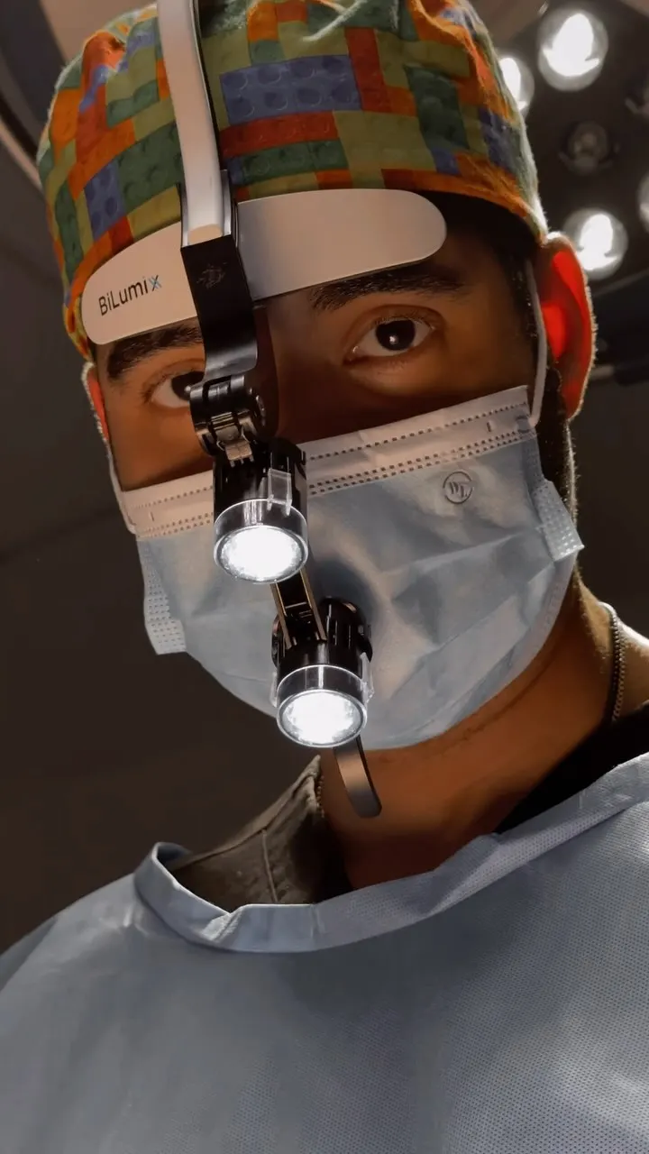 Close-up of Dr. Monta&ntilde;o focused during surgery, surgical loupes in view