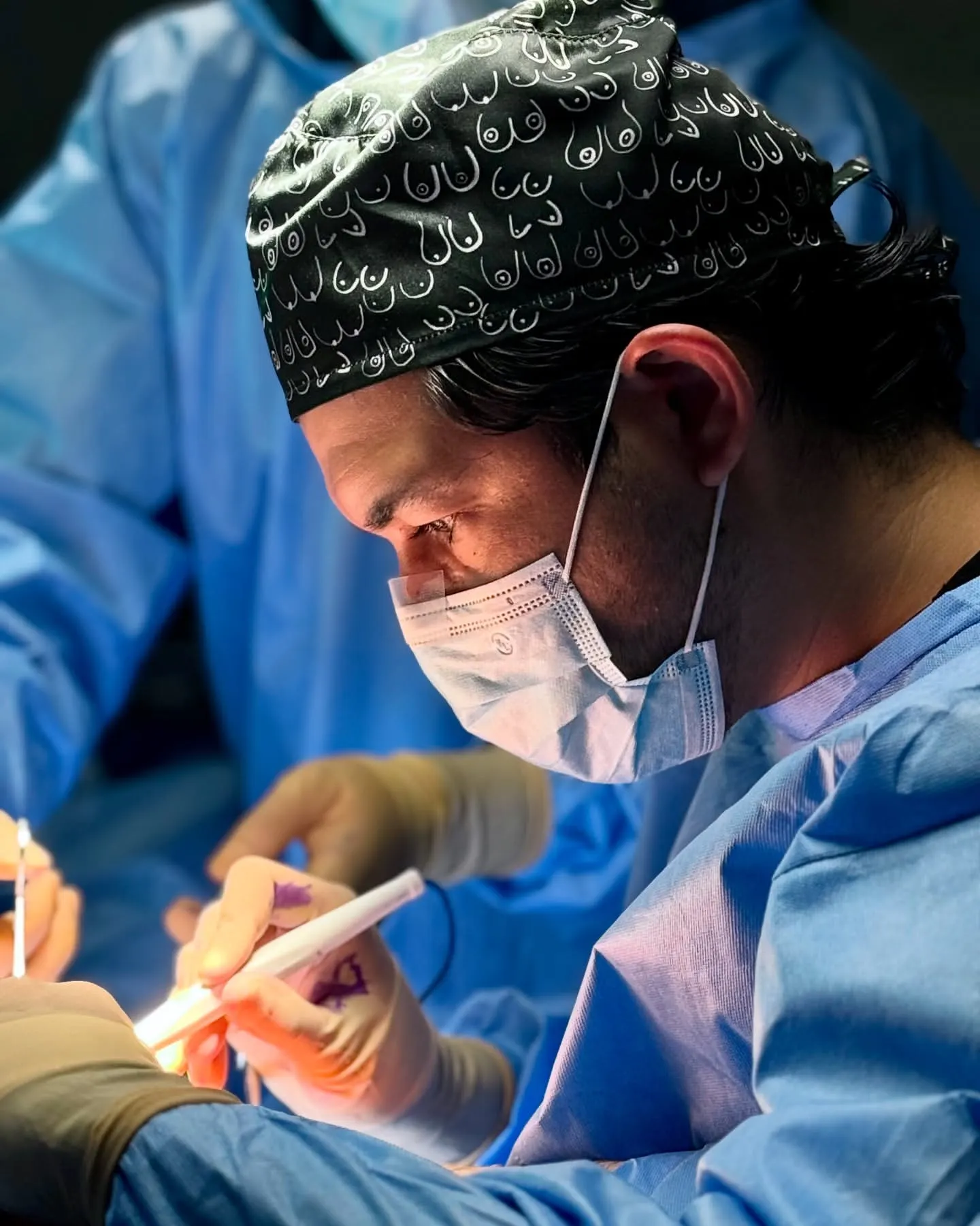 Dr. Otero drawing pre-operative skin markings on a draped patient