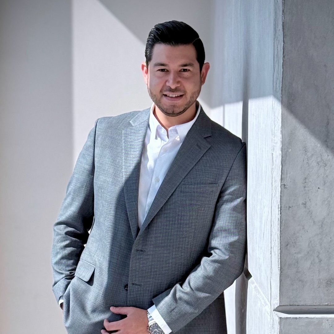 Dr. Rodrigo Otero in a grey suit, editorial portrait