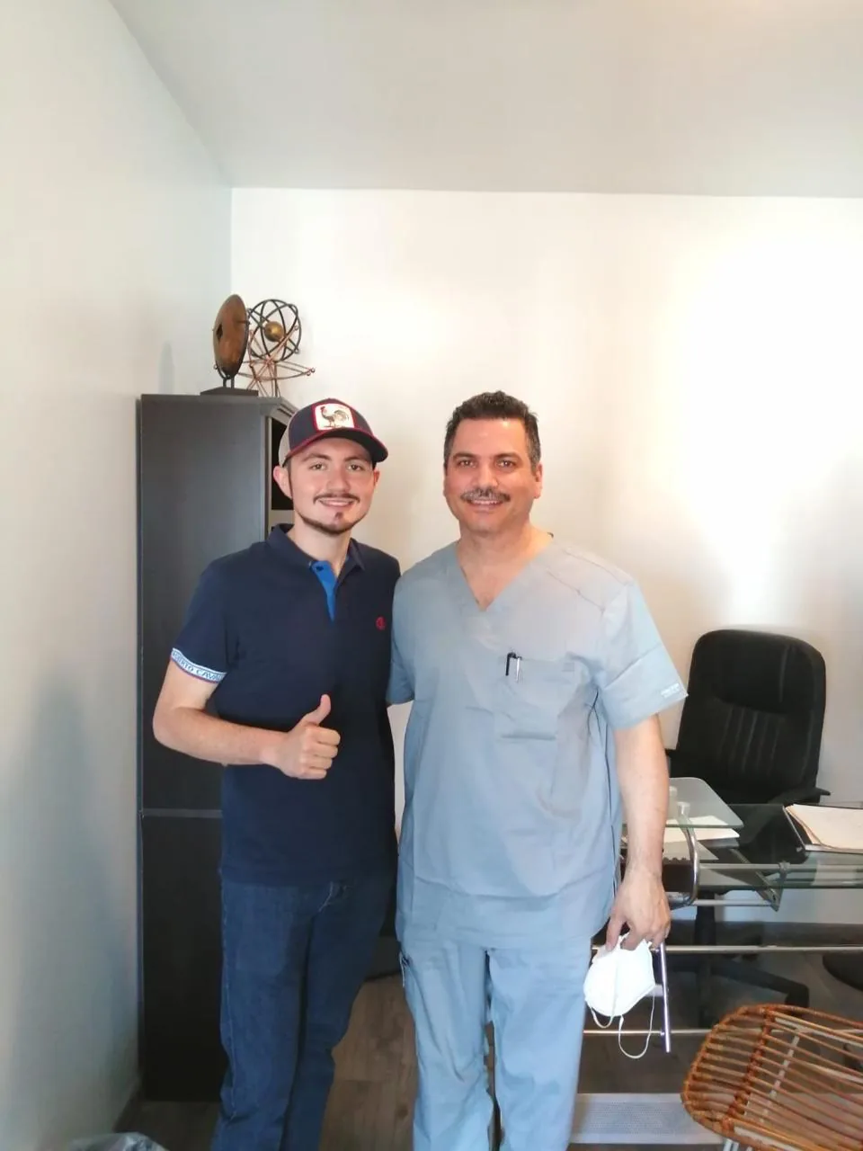 Dr. Mauricio Gutierrez in light-blue scrubs in his consultation office in Tijuana