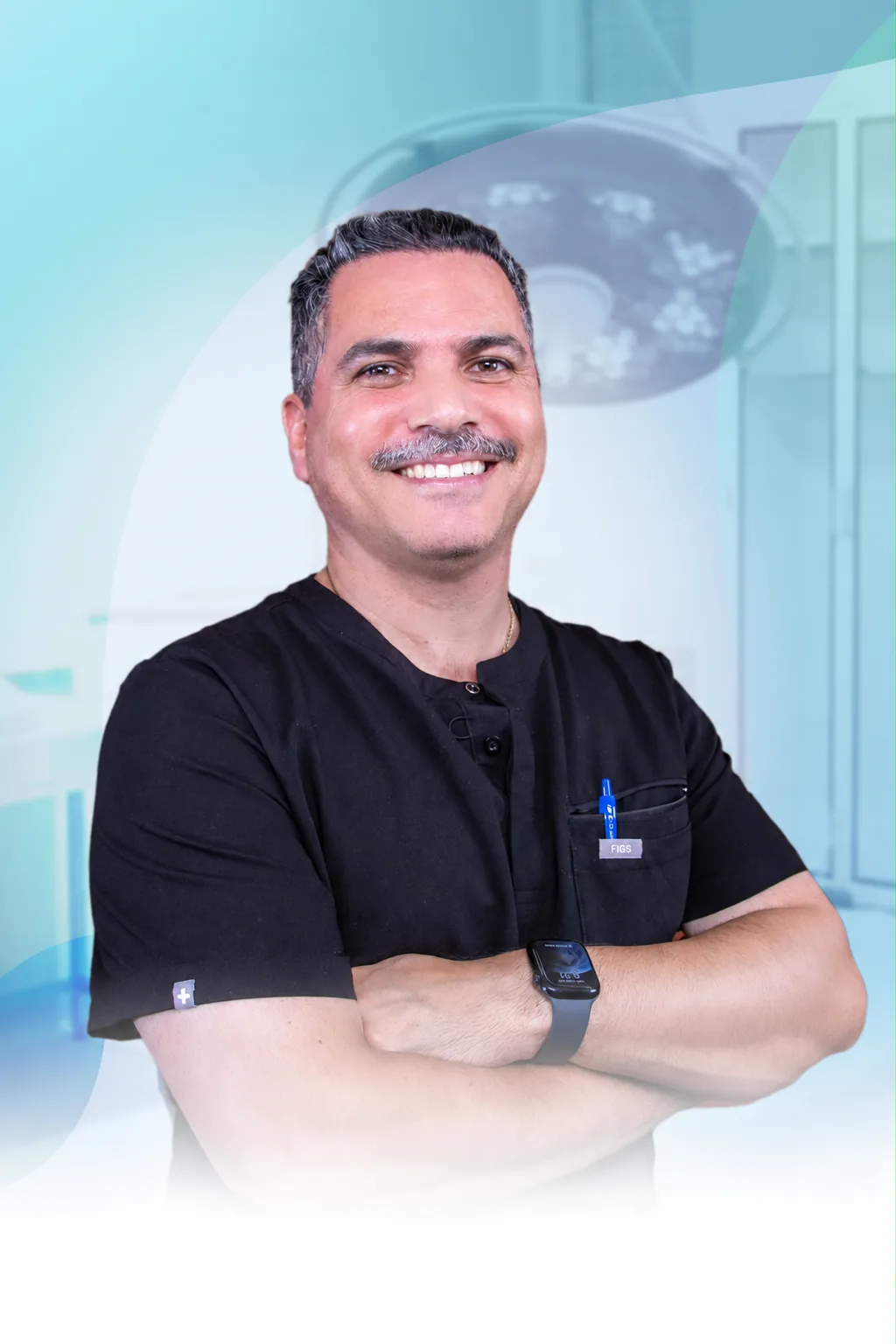 Dr. Mauricio Gutierrez, board-certified bariatric surgeon, in black scrubs with arms crossed beneath the operating-room lights