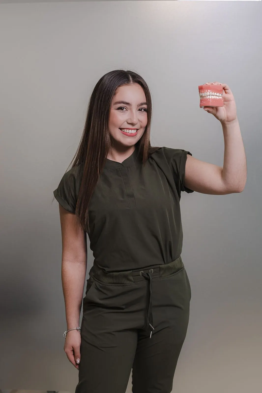 Dr. Rebeca Sanmiguel, Allure Dental Lead Restorative Dentist, holding a finished full-arch prosthetic