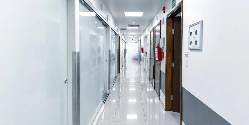 The long white main corridor inside the partner clinic in Tijuana coordinated by Allure RT MX.