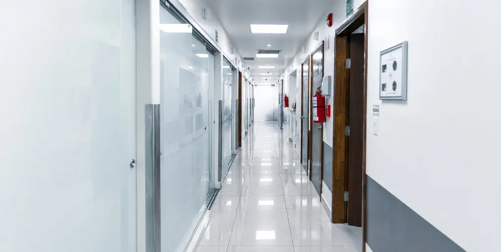 The main corridor of the partner clinic in Tijuana &mdash; calm, sun-lit, ready for the day&rsquo;s patients.