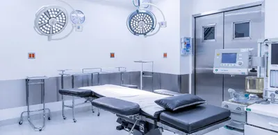 Closer view of the operating room with surgical lights and anesthesia equipment