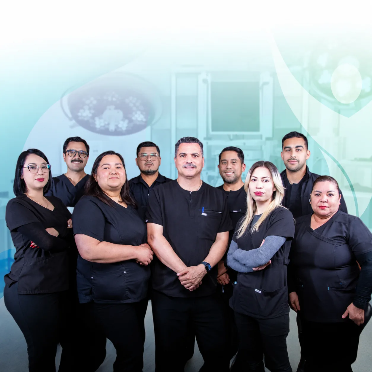 Dr. Mauricio Gutierrez and Dra. Silvia Castillo with their nine-person surgical team in black scrubs beneath the operating-room lights