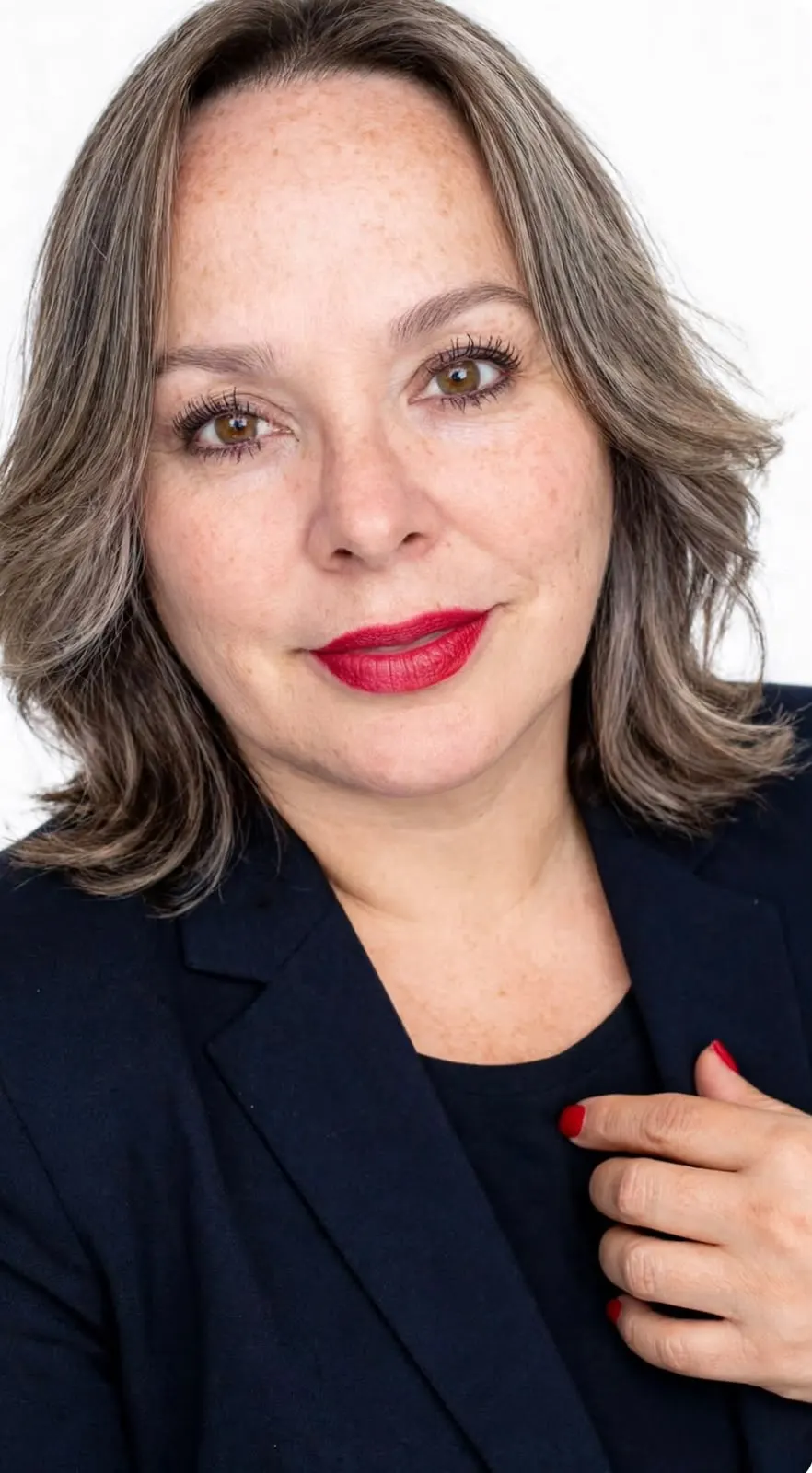 Nane Arenas, Patient Coordinator at Allure RT MX, in a navy blazer against a white backdrop