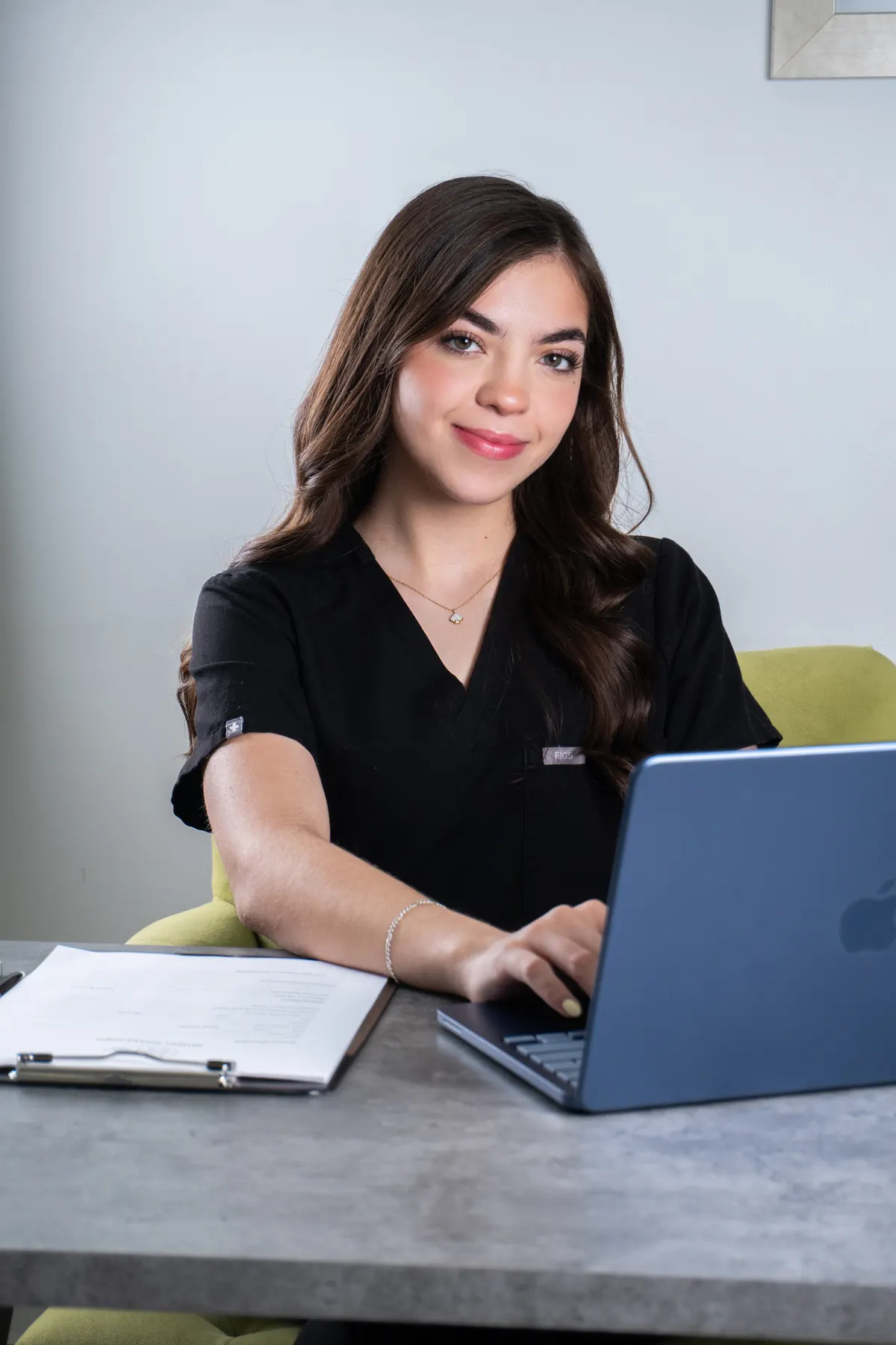 Natalia, patient coordinator, reviewing case at her desk