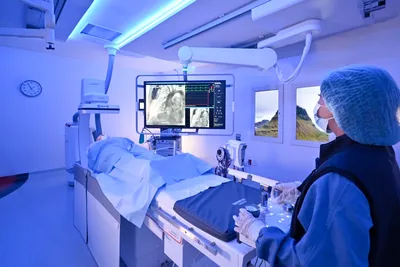Interventional procedure suite at Hospital Angeles Tijuana with live imaging displays and clinical staff