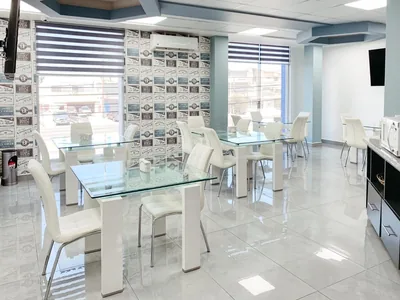 On-site cafeteria at Hospital Bellas Artes with glass tables and white chairs
