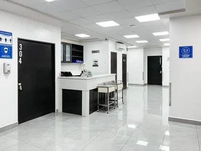Bright hospital corridor at Hospital Bellas Artes with polished floors and room signage