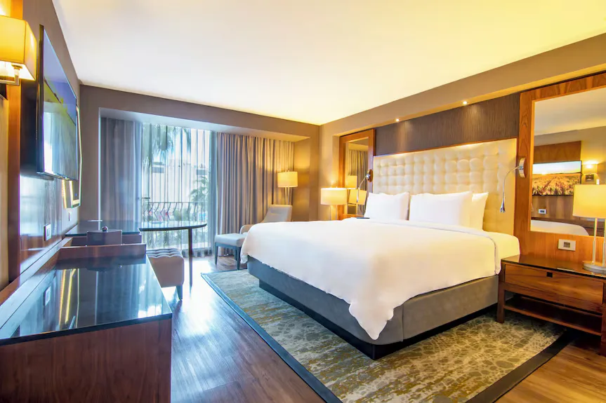 King suite at Hotel Lucerna Tijuana with tufted headboard and balcony