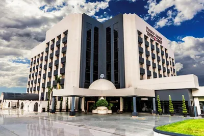 Daytime exterior of Hotel Pueblo Amigo in Tijuana with its white tower and covered entrance