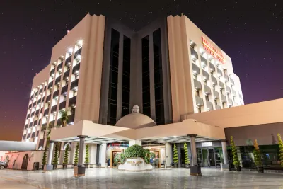Hotel Pueblo Amigo exterior at night with the entrance plaza lit up