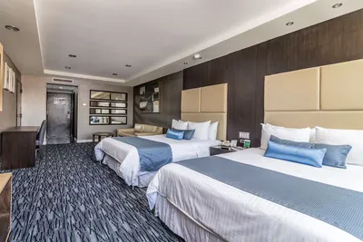 Double-queen room at Hotel Pueblo Amigo with upholstered headboards