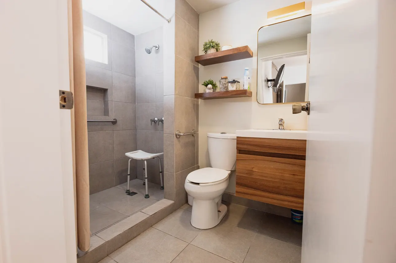 Accessible bathroom with walk-in shower, post-op shower seat and support rails